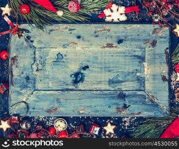 Wooden Christmas background in blue with red and white holiday decorations, top view , frame, horizontal