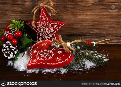 Wooden christmas star and heart decoration on wooden background