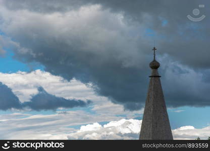 Wooden Church dome in the background of the tragic cloud of the sky