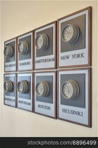 wooden clocks showing the time in different cities of the world on the wall