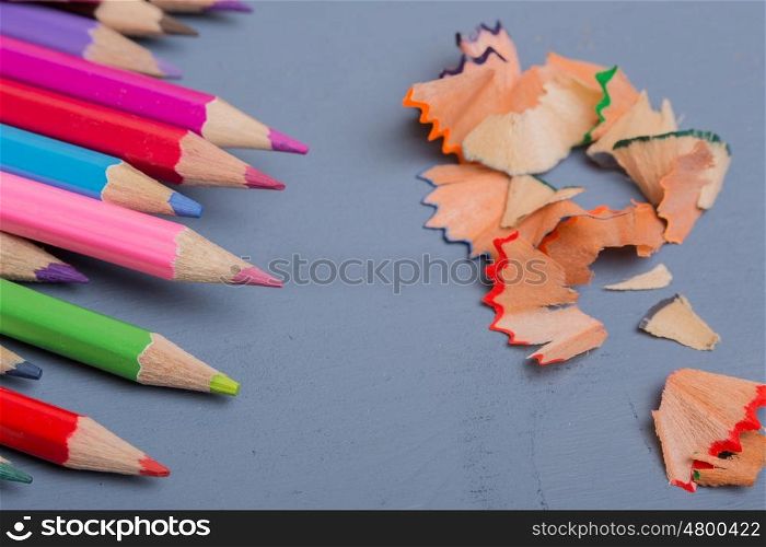 Wooden colorful pencils, on a blue wooden table