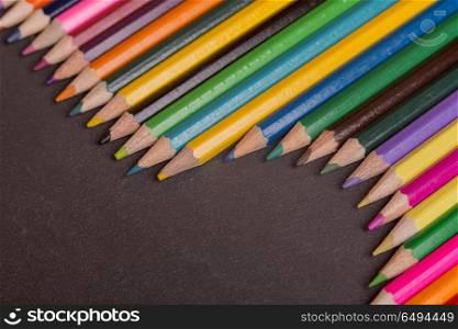 Wooden colorful pencils, on a dark background. colorful pencils