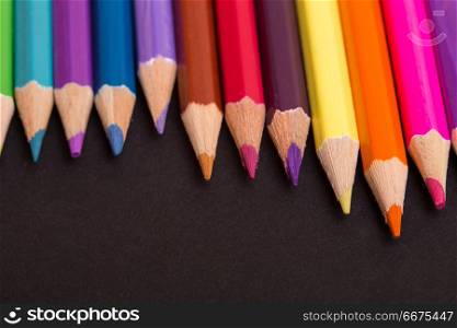 Wooden colorful pencils, on a dark background. colorful pencils