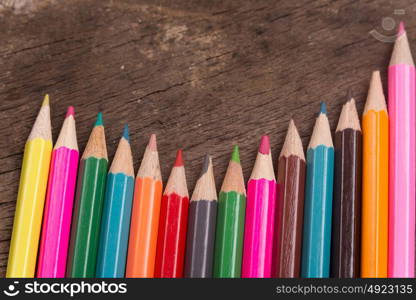 Wooden colorful pencils on a old wooden background