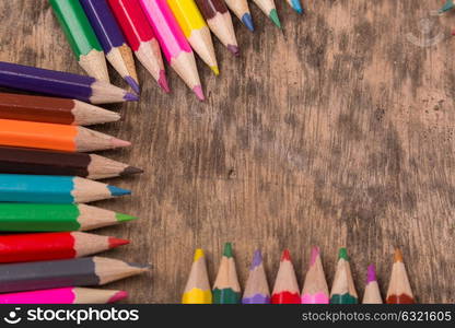 Wooden colorful pencils on a old wooden background