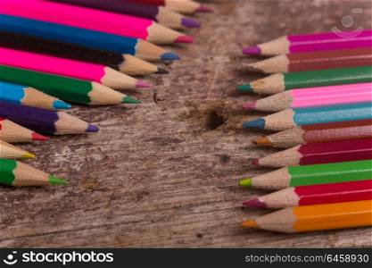 Wooden colorful pencils on a old wooden background