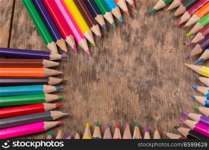 Wooden colorful pencils on a old wooden background