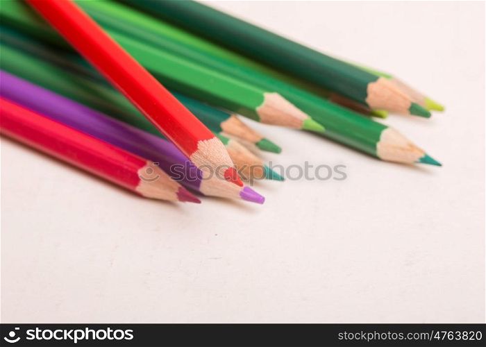 Wooden colorful pencils, on a white paper
