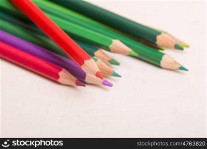 Wooden colorful pencils, on a white paper