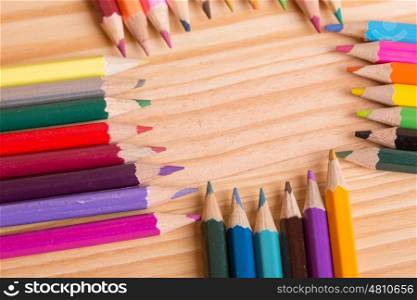 Wooden colorful pencils, on wooden table