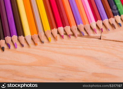 Wooden colorful pencils, on wooden table