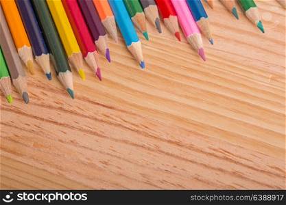 Wooden colorful pencils, on wooden table