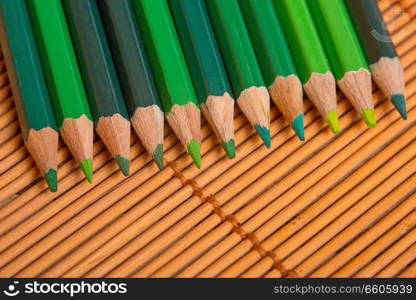 Wooden colorful pencils, on wooden table