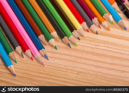 Wooden colorful pencils, on wooden table