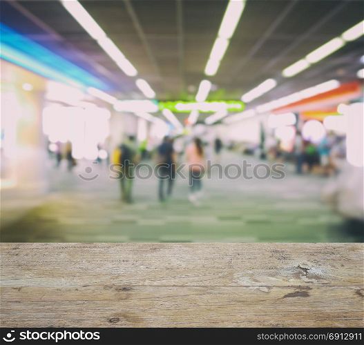wooden counter top with blurred walk way to boarding gate at airport