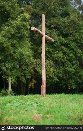 Wooden cross on a hill, symbol for the crucifixion of Jesus.