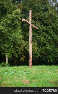 Wooden cross on a hill, symbol for the crucifixion of Jesus.