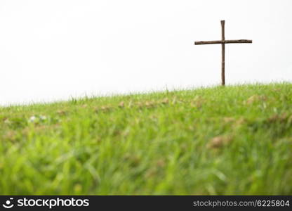 Wooden cross on a hill, symbol for the crucifixion of Jesus.