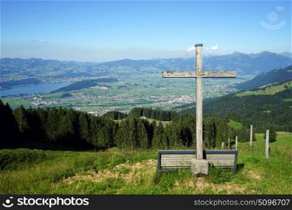 Wooden cross on the hill and lake Zurich in Switzerland
