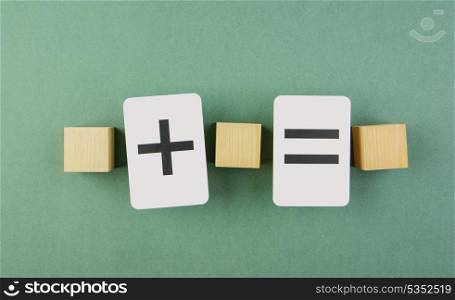 wooden cube and school card with math problems