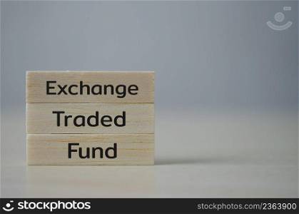 wooden cube block icon ETF Exchange Traded Fund on table.Business stock market finance Index Fund Concept.