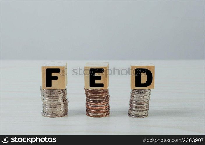 wooden cube block on coins FED text Business Financial Management Economic concepts.
