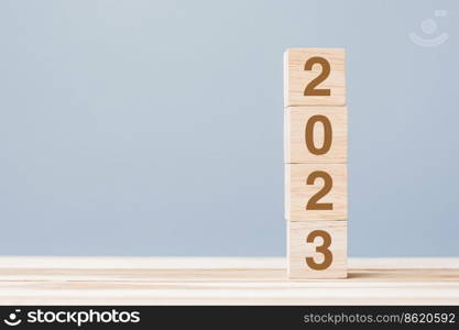 wooden cube block with 2023 text on table background. Resolution, plan, review, goal, start and New Year holiday concepts