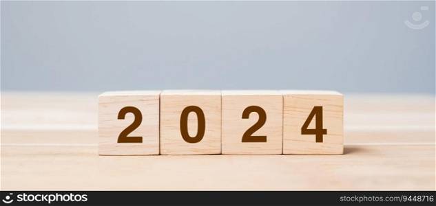 wooden cube block with 2024 text on table background. Resolution, plan, review, goal, start and New Year holiday concepts