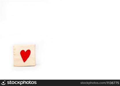 Wooden cube with a red heart symbol isolated on white background with space for text, valentines concept close-up. Wooden cube with a red heart symbol isolated on white background with space for text, valentines concept