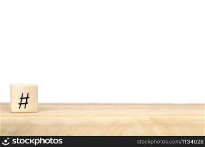 Wooden cube with hashtag near white background, social media concept, space for text close-up. Wooden cube with hashtag near white background, social media concept, space for text