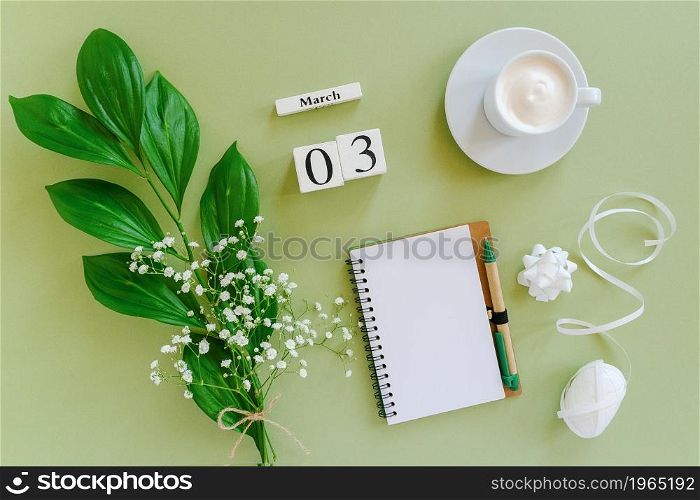 Wooden cubes calendar March 3. Open blank notepad, cup of coffee, bouquet flowers on green background. Concept hello spring Creative Top view Flat lay Mock up.. Wooden cubes calendar March 3. Open blank notepad, cup of coffee, bouquet flowers on green background. Concept hello spring Top view Flat lay Mock up