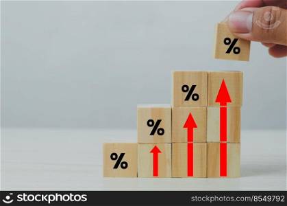 Wooden cubes inflation and arrow red with wood cube percentage symbol on background and copy space.Business finance concepts.