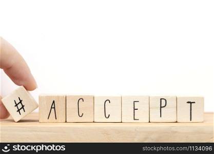 Wooden cubes with a hashtag and the word Accept, social media concept near white background close-up. Wooden cubes with a hashtag and the word Accept, social media concept near white background