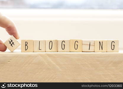 Wooden cubes with a hashtag and the word blogger, social media concept background. Wooden cubes with a hashtag and the word blogger, social media concept