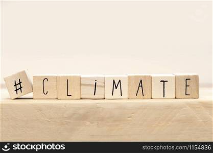 Wooden cubes with a Hashtag and the word Climate, social media and environment concept near white background space for text. Wooden cubes with a Hashtag and the word Climate, social media and environment concept near white background