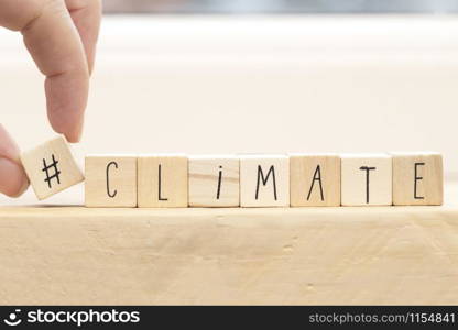 Wooden cubes with a Hashtag and the word Climate, social media and environment concept near white background space for text. Wooden cubes with a Hashtag and the word Climate, social media and environment concept near white background