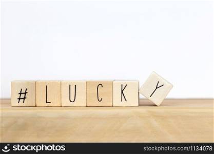 Wooden cubes with a hashtag and the word lucky background, social media concept close-up. Wooden cubes with a hashtag and the word lucky background, social media concept