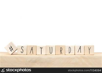 Wooden cubes with a hashtag and the word Saturday, social media concept near white background close-up. Wooden cubes with a hashtag and the word Saturday, social media concept near white background