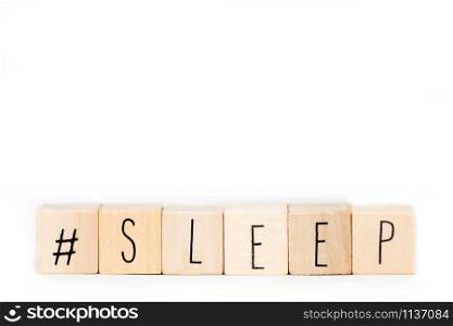 Wooden cubes with a Hashtag and the word Sleep isolated on white background, social media concept space for text close-up. Wooden cubes with a Hashtag and the word Sleep isolated on white background, social media concept space for text