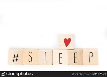 Wooden cubes with a Hashtag and the word Sleep isolated on white background, social media concept space for text close-up. Wooden cubes with a Hashtag and the word Sleep isolated on white background, social media concept space for text
