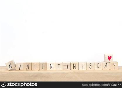 Wooden cubes with hashtag and the word valentine&rsquo;s day, social media concept background close-up. Wooden cubes with hashtag and the word valentine&rsquo;s day, social media concept background