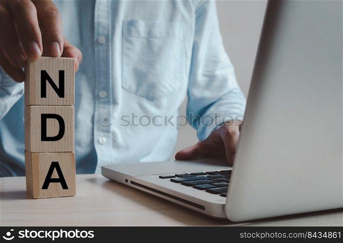 Wooden cubes with NDA Non disclosure Agreement symbol on background and copy space.Business concepts.