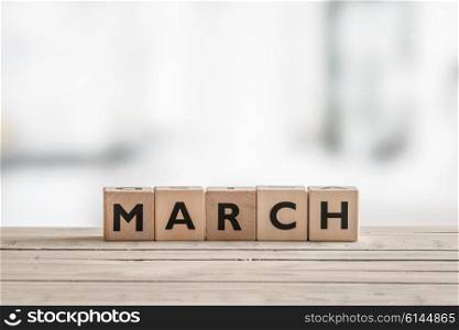 Wooden cubes with the word march on a desk