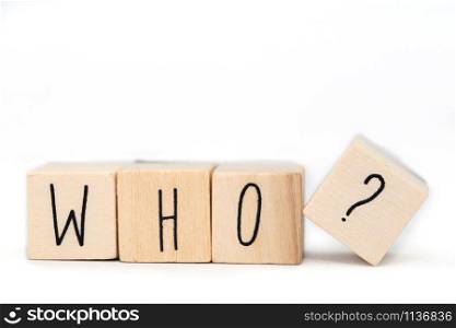 Wooden cubes with the word Who and a question mark isolated on white background close-up. Wooden cubes with the word Who and a question mark isolated on white background
