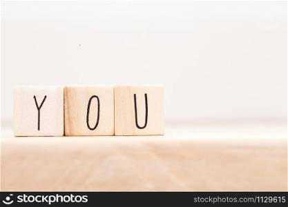 wooden cubes with words You at white background. Copy space. YOU Close-up. wooden cubes with words You at white background. Copy space. YOU