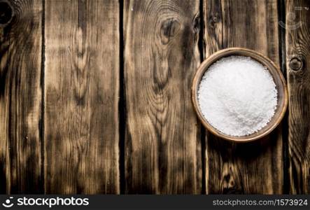 Wooden Cup with salt . On a wooden background. . Wooden Cup with salt . On wooden background.