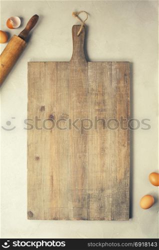 Wooden cutting board and baking imgredients. Top view, copyspace