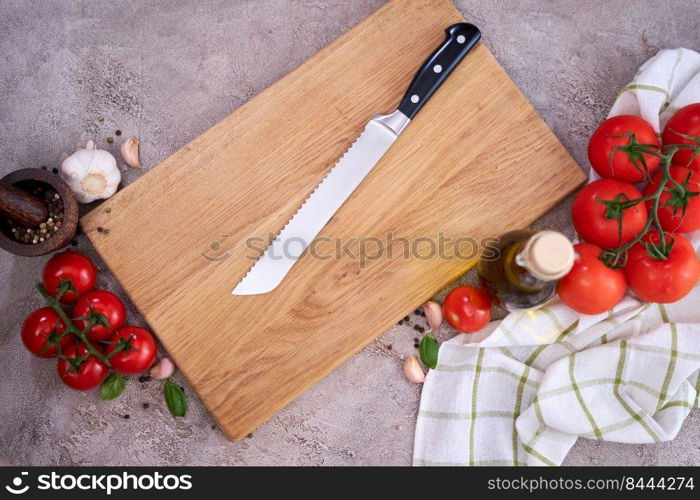 wooden cutting board and Steel kitchen bread knife on grey kitchen tab≤.. wooden cutting board and Steel kitchen bread knife on grey kitchen tab≤