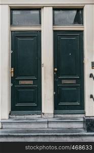 Wooden dark dutch classic closed doors at house facade