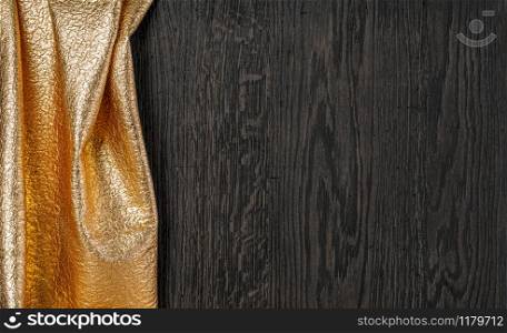 wooden dark texture with gold textil, with copy space